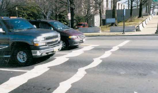 1. Observe the warped lines on asphalt pavement in front