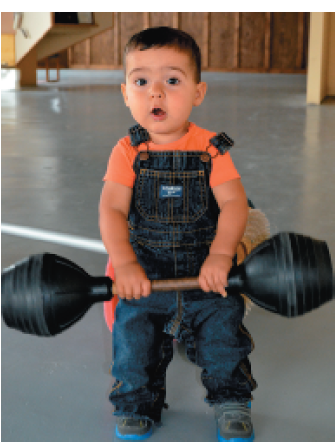Little Hudson holds the 10-kg barbell 0.3 m above the