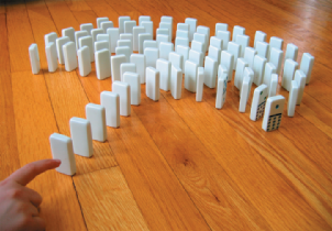 Stand one domino upright so that when it topples, it