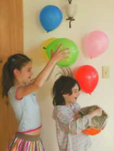 The children in Figure Q17.8 are rubbing balloons on their